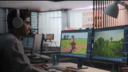 Game developer working on a 3D character model across dual monitors